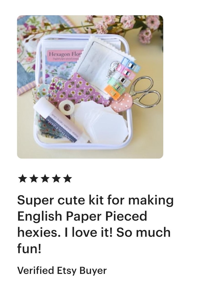 May include: A clear plastic container filled with craft supplies for English Paper Piecing. Includes fabric, scissors, clips, glue, and paper pieces. The kit is labeled "Hexagon Flower".