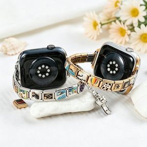 May include: Two smartwatches with decorative charm bracelets. One watch is black with a silver band, the other is silver with a gold band. The bracelets feature colorful charms with various designs, including a hot air balloon and a horse.