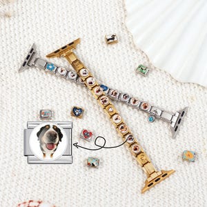May include: Two watch bands, one gold and one silver, adorned with dog-themed charms. Additional charms with dog and heart designs are scattered around. A large charm with a dog's face is also present, showcasing a Bernese Mountain Dog.