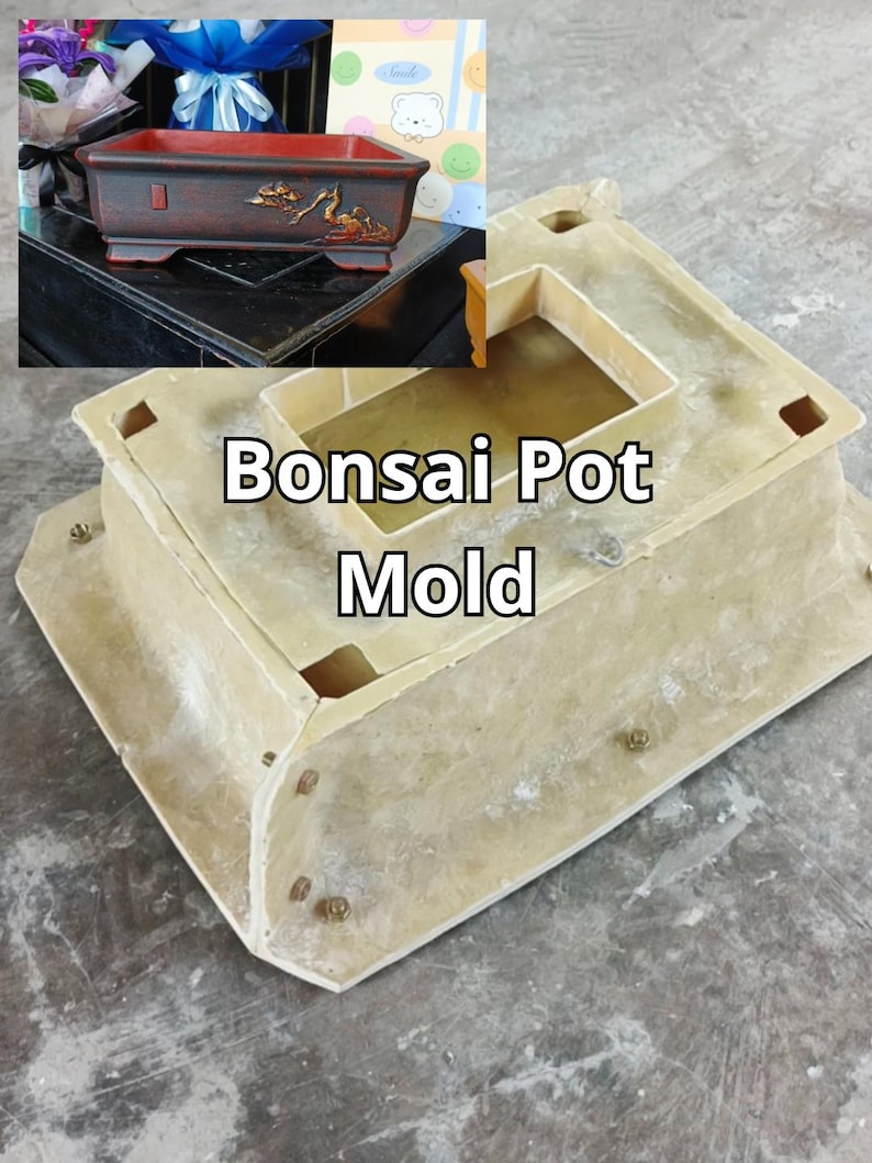 May include: A beige bonsai pot mould with the text "Bonsai Pot Mold" in the centre. The mould has a rectangular shape with a recessed interior and several small square holes. A decorative bonsai pot is visible in the background.