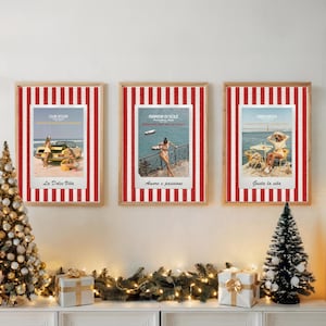 May include: Three framed vintage-style travel posters with red and white striped borders. Each poster features a different image and text in a retro Polaroid style. The posters are displayed above a decorated shelf with Christmas decor.
