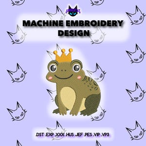 May include: Machine embroidery design featuring a cartoon frog wearing a gold crown. The frog is green and tan with rosy cheeks and large eyes. The design is set against a light purple background with cat-shaped graphics and the text "MACHINE EMBROIDERY DESIGN".