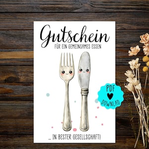 May include: A white card with the German word "Gutschein" and the phrase "für ein gemeinsames Essen" in black script. The card features illustrations of a smiling fork and knife. The text "... in bester Gesellschaft!" is at the bottom, with a PDF download icon.