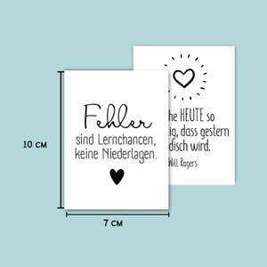 May include: Two white rectangular cards, 10 cm x 7 cm, with black text and heart graphics. One card reads "Fehler sind Lernchancen, keine Niederlagen." The other card has a heart graphic and text from Will Rogers.