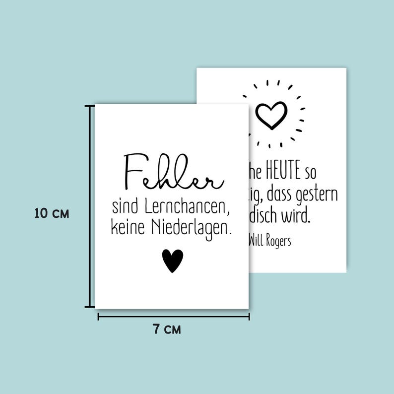 May include: Two white rectangular cards, 10 cm x 7 cm, with black text and heart graphics. One card reads "Fehler sind Lernchancen, keine Niederlagen." The other card has a heart graphic and text from Will Rogers.