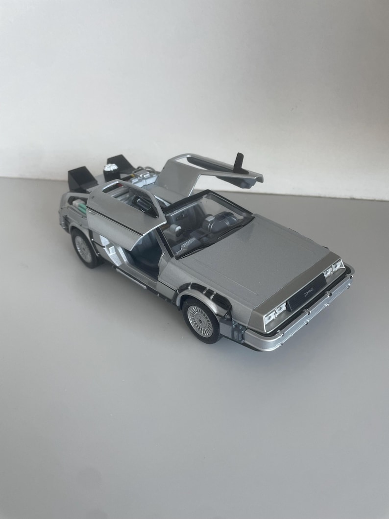 Back to the Future DeLorean time machine replica diecast model car: metal collectible with opening gullwing doors, detailed movie car model, display piece gift for BTTF fans