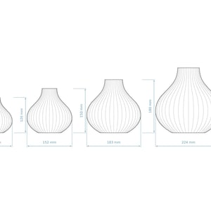 May include: Line drawing of four decorative vases in varying sizes. The smallest vase is 12.2 cm tall, the next is 12 cm tall, the third is 15 cm tall, and the largest is 22 cm tall. Each vase has vertical lines.
