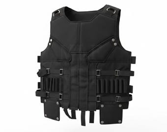 May include: Black tactical vest with multiple pockets, straps, and metal buckles. The vest has a padded design and is made of a durable material. It features several pouches and loops for carrying equipment. The vest is designed for protection and utility.