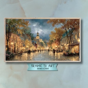 Puede incluir: Una impresión artística digital enmarcada que representa una escena de calle europea al anochecer. La obra presenta una calle adoquinada, edificios con iluminación cálida y figuras caminando. Se muestra el texto "FRAME TV ART" y la resolución 3840 x 2160.