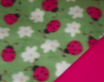 Pink Ladybugs Baby Blanke  with a Hot Pink  Backing . Double Fleece Sewn Together