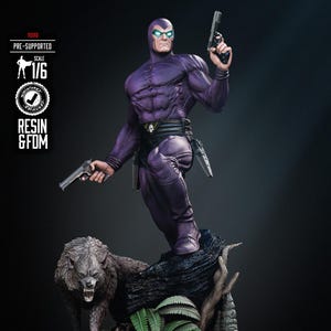 May include: A purple resin figure of a masked superhero holding two pistols, standing on a rocky base with a snarling wolf and other creatures. The figure is 1/6 scale and pre-supported. The text "RESIN & FDM" is visible.