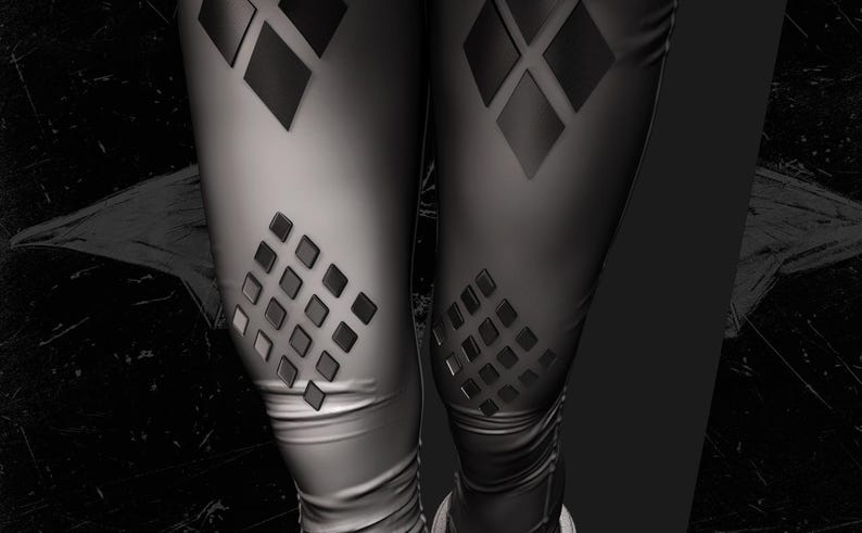 May include: Black leggings with diamond-shaped cutouts. The leggings have a shiny, smooth texture and a form-fitting design. The diamond cutouts are arranged in a grid pattern on the thighs and knees.