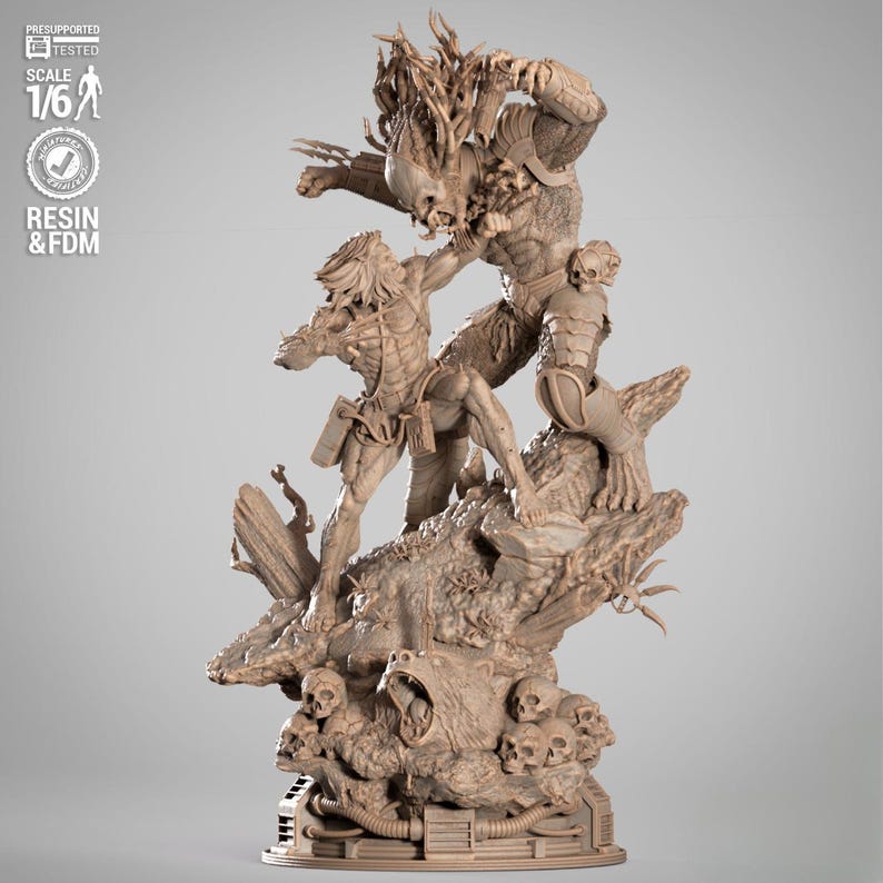 May include: A detailed resin statue depicting a battle scene between two Predator figures. The figures are intricately sculpted, showcasing their armor and weaponry. The base features skulls and a snarling bear. The statue is labeled "SCALE 1/6" and "RESIN & FDM".