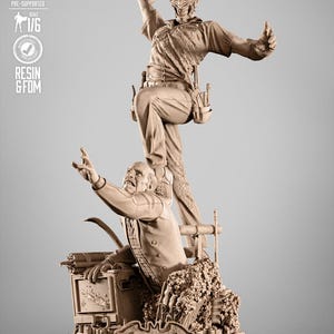 May include: A detailed resin statue featuring the Joker standing over a seated figure. The statue is a 1/6 scale model, with the Batman logo visible. The Joker is in a dynamic pose, and the base includes the Batman logo.