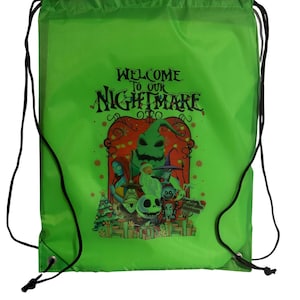 May include: Green drawstring bag featuring a colorful graphic from "The Nightmare Before Christmas." The image includes characters like Jack Skellington, Sally, and Oogie Boogie, with the text "WELCOME TO OUR NIGHTMARE."