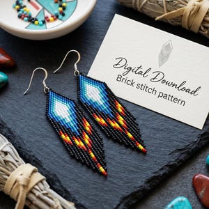 May include: A pair of beaded earrings with a feather design. The earrings feature a gradient of colors, including blue, white, yellow, and red, with black fringe. The image also includes a card that says "Digital Download Brick stitch pattern".