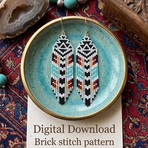 May include: A pair of long, pointed earrings crafted with small beads in a geometric pattern of black, white, red, and turquoise. The earrings feature gold-tone hooks and are displayed on a card with the text Digital Download Brick stitch pattern.