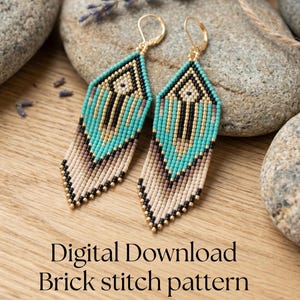 May include: A pair of beaded earrings with a geometric design. The earrings feature turquoise, black, gold, and beige beads, with a fringe at the bottom. The earrings are displayed on a wooden surface with lavender sprigs and stones. Text on the image reads "Digital Download Brick stitch pattern."