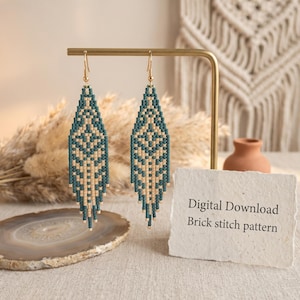 May include: Two beaded earrings with a geometric pattern in teal and beige, hanging from gold-colored hooks. The earrings are displayed on a gold stand. A card reads "Digital Download Brick stitch pattern".