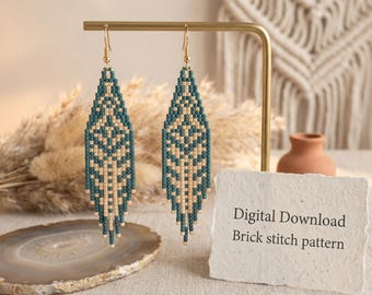 May include: A pair of teal and beige beaded earrings with a geometric design, suspended from gold-coloured hooks. The earrings are displayed on a gold stand. A card reads "Digital Download Brick stitch pattern".
