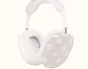 May include: White over-ear headphones with a light gray polka dot design on the earcups. The headphones have a padded headband and earcups for comfort. The design is modern and minimalist.