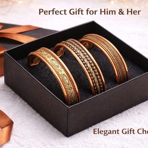 May include: Three copper-toned metal cuff bracelets with intricate embossed patterns, displayed inside a black square gift box. The text Perfect Gift for Him & Her and Elegant Gift Choice is printed on the white surface near the box.