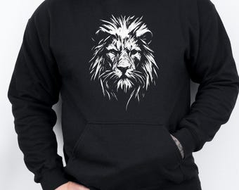 May include: Black hoodie with a white lion face design. The lion's mane and features are intricately drawn. The hoodie includes a kangaroo pocket and a hood with a drawstring. The word "black" is visible at the bottom left.