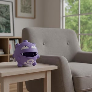 May include: A purple cartoon character with a large grin and white eyes is on a light wooden table. The figure has a round body and small legs. A grey armchair and a window are in the background.