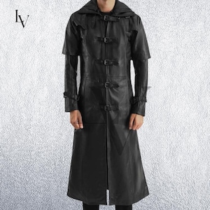 May include: Black leather coat with a hooded design and multiple buckle closures. The long coat features a knee-length hem and short sleeves, offering a unique style. The coat is made of a smooth, dark material.