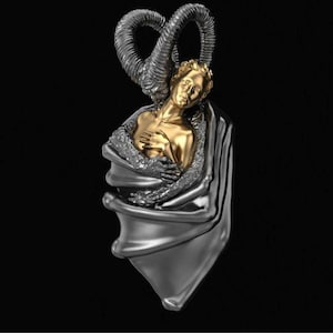 May include: A pendant featuring a gold-colored figure embraced by a silver-colored form with curved horns. The figure is in a draped silver-colored garment, with the horns arching above. The background is black.