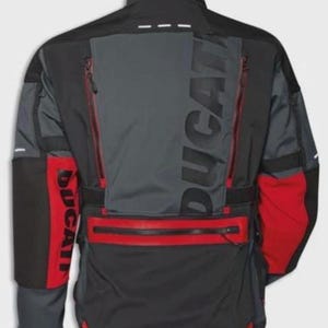 May include: Black, gray, and red motorcycle jacket with the brand name "DUCATI" prominently displayed. The jacket features multiple zippered pockets, reflective accents, and a high collar. The design incorporates color-blocked panels and a streamlined silhouette.