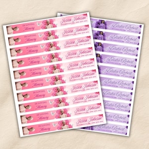 May include: Two sheets of rectangular memorial labels. The left sheet features pink backgrounds with roses, white doves, the text In Loving Memory, and the name Jesica Johnsan with dates. The right sheet has purple backgrounds with roses and the name Elisha Robert.