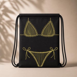 May include: Black drawstring backpack featuring a yellow line drawing of a bikini. The bikini top and bottom are outlined with a scalloped edge and vertical lines. The drawstring is black.