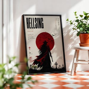 May include: Framed poster featuring the word "HELLSING" in bold black letters above Japanese text. The artwork depicts a silhouette of a figure in a long coat and hat, holding a gun, against a red sun. The poster has a black frame.