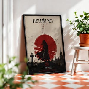 May include: Framed poster featuring the word "HELLSING" above a red sun design with a silhouetted figure. The poster has Japanese text and a graveyard scene with a cross. The frame is black.