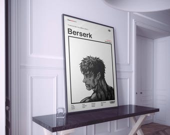 May include: A framed poster with a black and white illustration of a man's profile. The poster is titled "Berserk" with the year 1997. The poster is displayed on a dark brown table against a white wall.