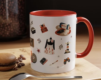 May include: A white ceramic mug with a bright red interior and handle, featuring a pattern of small illustrations including a life vest, a milk carton, a lighthouse, binoculars, a dress, a cigarette, and a box labeled RUN, all in a graphic style.