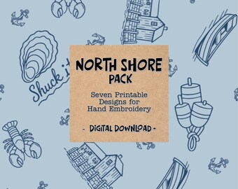 May include: A digital download pack featuring seven printable hand embroidery designs on a light blue background. The pattern includes dark blue line art of lobsters, anchors, boats, lighthouses, and oysters with the text North Shore Pack.