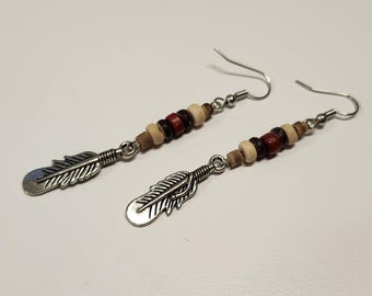 Handmade earrings with tan blue red wood beads with silver feather charms