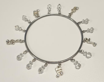 Music notes, Treble clef, and crystal charms on handmade bangle bracelet in silver