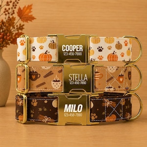 May include: Three stacked pet collars with gold-tone metal buckles. The top collar is white with orange pumpkins and brown paw prints, labeled COOPER 123-456-7890. The middle is tan with coffee mugs and cinnamon, labeled STELLA 123-456-7890. The bottom is dark brown with pumpkins and cinnamon, labeled MILO 123-456-7890.
