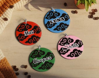 May include: Four colorful, round pet tags with names: Max, Luna, Stella, and Cooper. Each tag features a unique color: red, blue, pink, and green, with black cloud designs and the pet's name in white script. They have a silver loop for attachment.