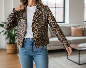 May include: A brown and black leopard print jacket with a zipper closure. The jacket is worn over a white t-shirt and blue jeans. The jacket has a classic biker style with a notched collar and long sleeves.