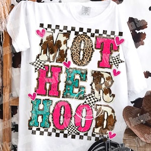 May include: White t-shirt with the text "NOT HER HOOD" in a mix of fonts and patterns, including cow print, leopard print, and pink lettering. The design is accented with hearts and checkered flag elements. A cowboy hat and boots are visible.