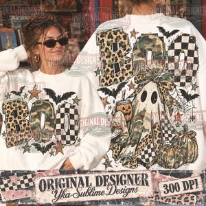 May include: A white long-sleeve sweatshirt featuring a graphic print with the word BOO in leopard, camouflage, and checkered patterns. The design includes a ghost wearing a bow, pumpkins, bats, stars, and spiderwebs in a festive Halloween theme.
