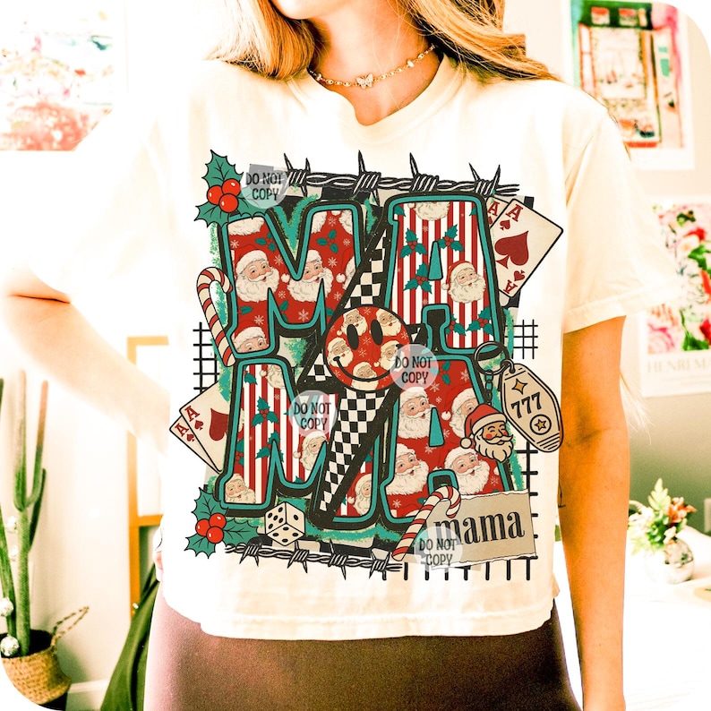 May include: Cream-coloured t-shirt featuring a festive "MAMA" graphic. The design includes Santa Claus, candy canes, playing cards, and a lucky 777 charm. The words "DO NOT COPY" are also visible.