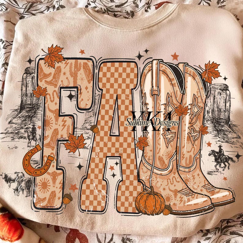 May include: Cream-coloured sweatshirt with a "FA" graphic. The letters are filled with a western-themed pattern and a checkered design. The "M" is filled with cowboy boots. The design includes autumn leaves, stars, and a pumpkin. The text "Sublime Designs" is also present.