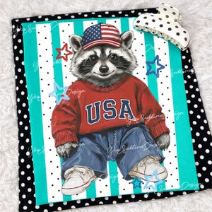 May include: A patriotic raccoon illustration wearing a red sweater with "USA" in white letters, blue jeans, and a baseball cap with an American flag design. The background features a teal and white striped pattern with star accents.