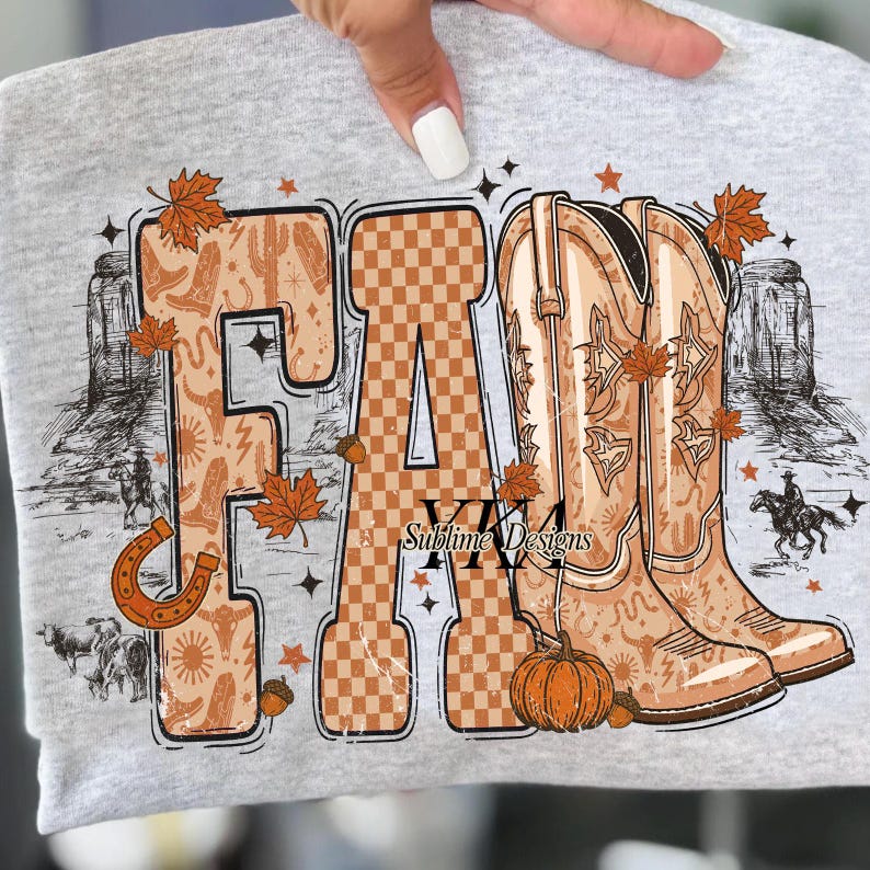 May include: A light grey sweatshirt featuring the word "FALL". The letters are decorated with autumn and Western-themed imagery. The "F" is filled with cowboy boots and cacti, the "A" has a checkered pattern, and the "L" has cowboy boots. Includes a pumpkin and leaves.