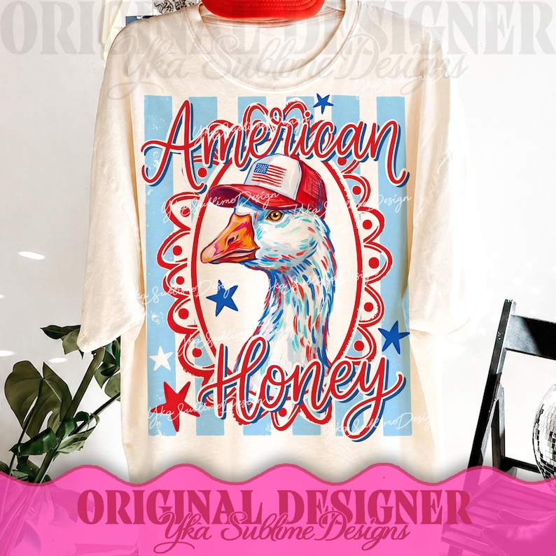 May include: Cream-colored t-shirt featuring a patriotic design. The graphic includes a goose wearing a red, white, and blue hat, with the words "American Honey" in red script. Blue stars and stripes complete the design.